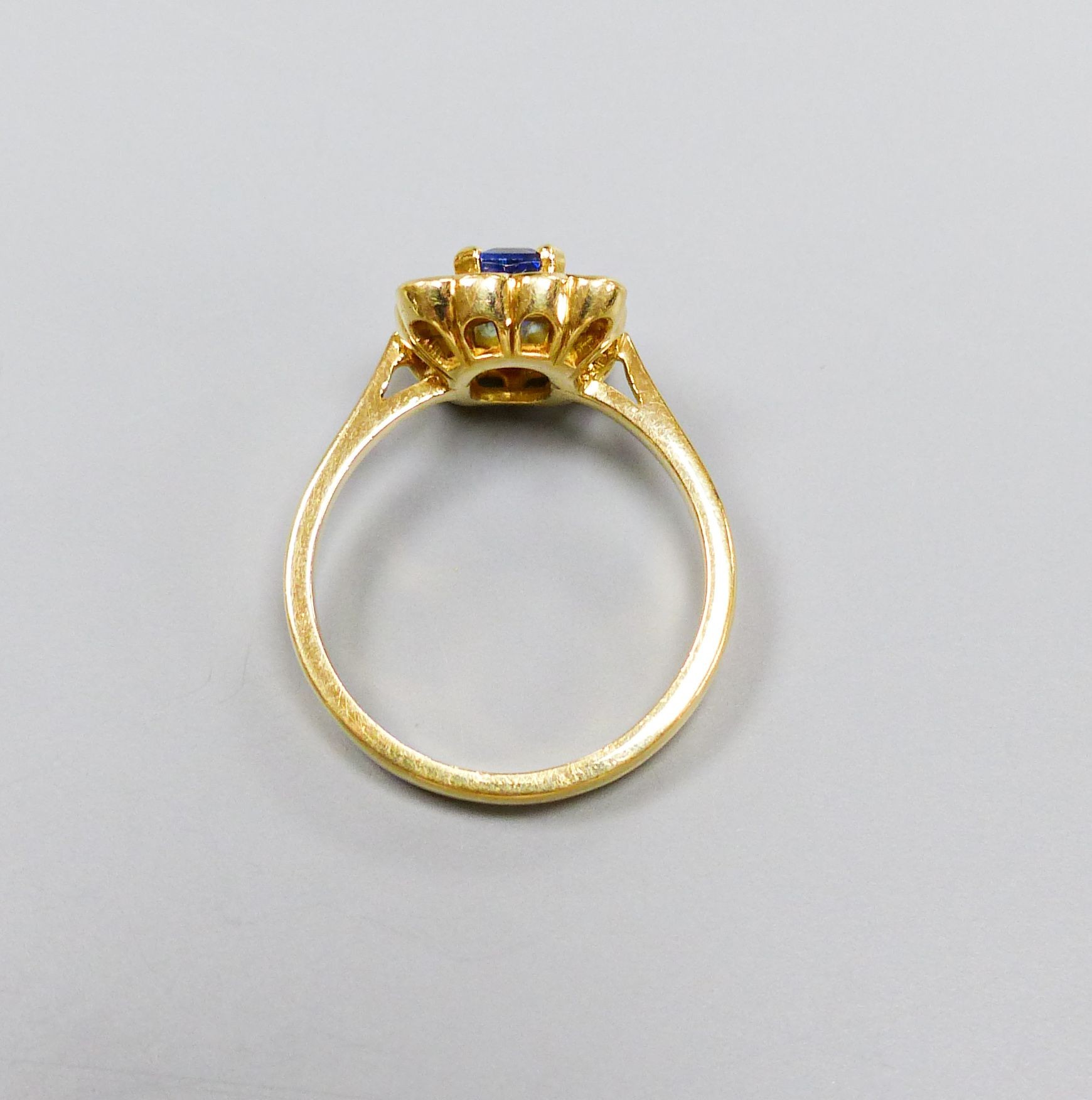 A modern 18ct gold, sapphire and diamond set square cluster ring, size M, gross weight 4.2 grams